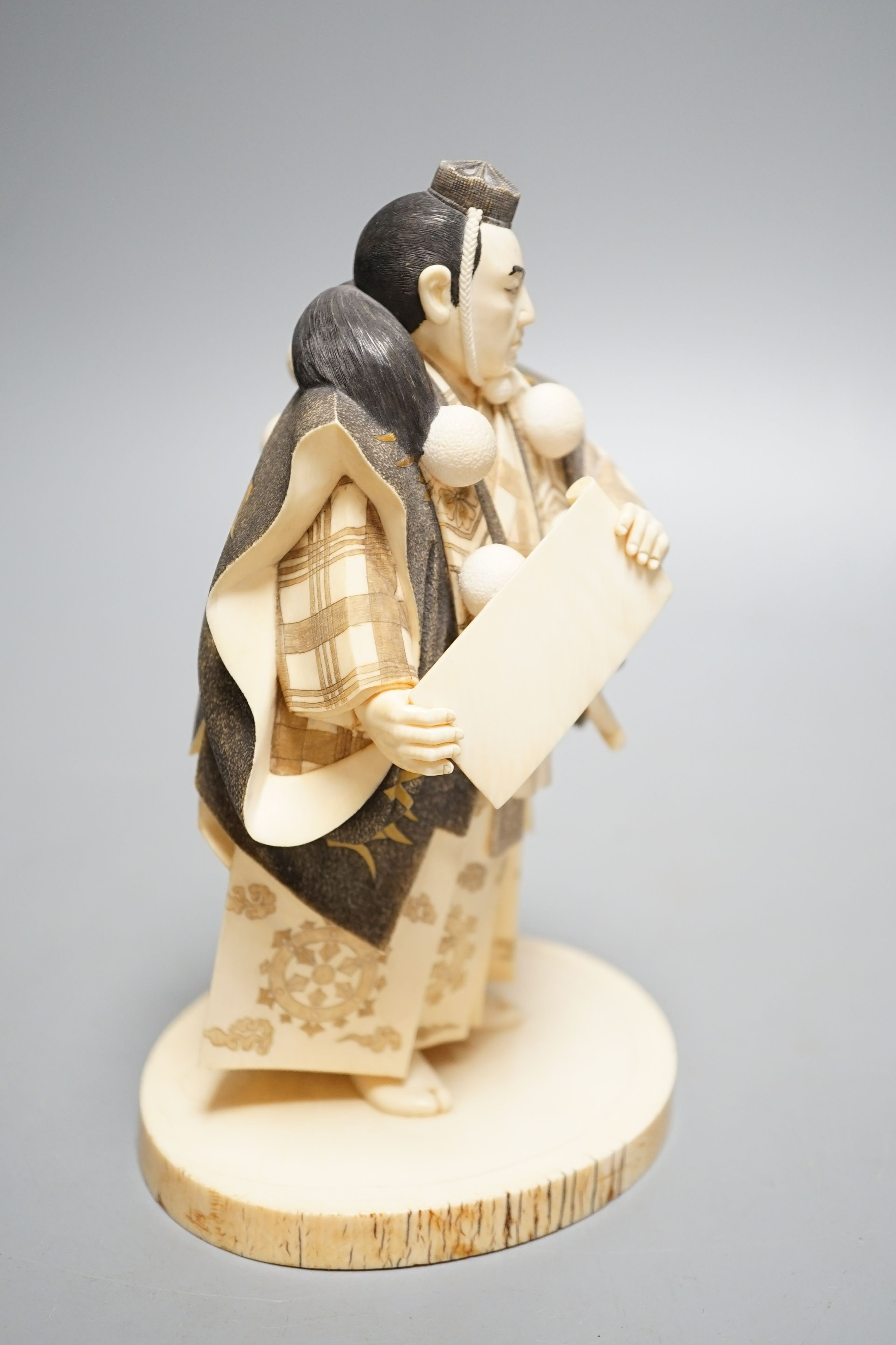 A Japanese ivory figure of a Yamabushi warrior monk, Taisho/early Showa period, signed to a lacquer tablet - 18.5cm tall